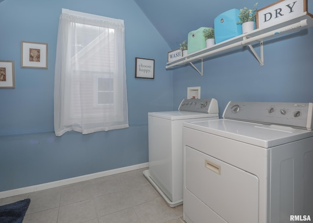 washroom featuring light tile patterned flooring and washer and dryer