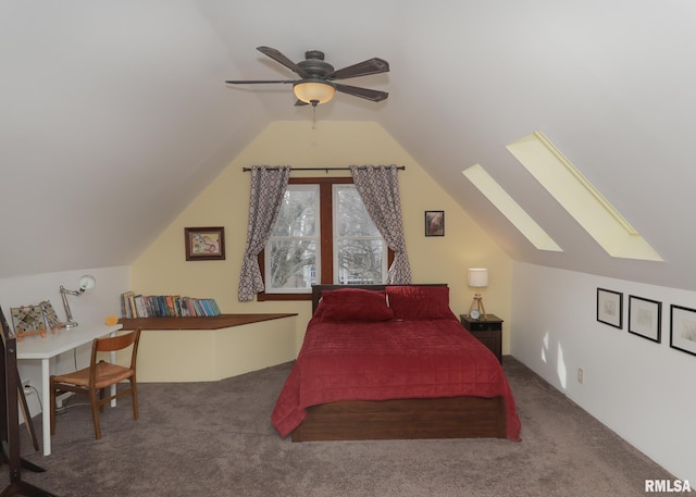 carpeted bedroom featuring lofted ceiling with skylight and ceiling fan