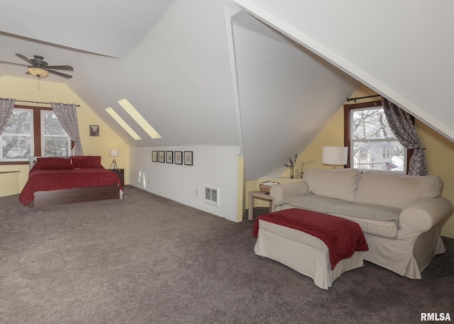 bedroom with vaulted ceiling with skylight and dark colored carpet