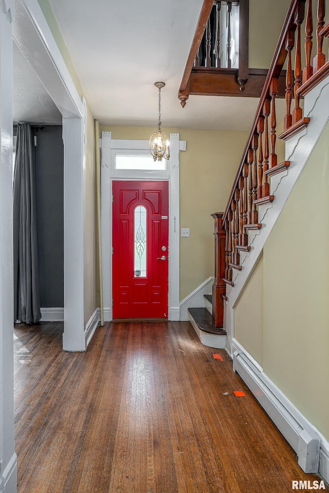 foyer featuring a baseboard heating unit, an inviting chandelier, and dark hardwood / wood-style flooring