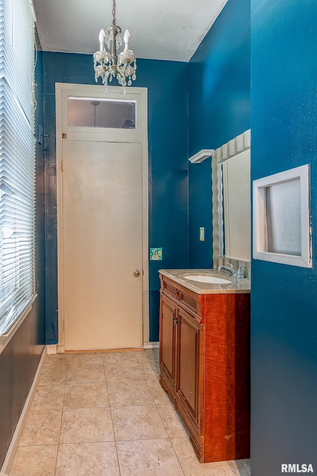 bathroom with vanity, tile patterned floors, and an inviting chandelier