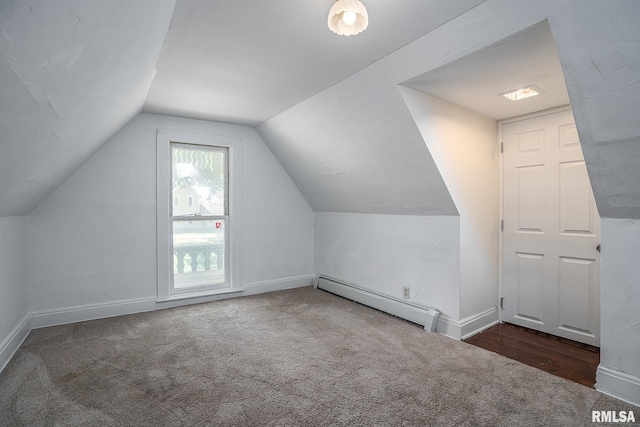 bonus room with lofted ceiling, a baseboard radiator, and dark colored carpet