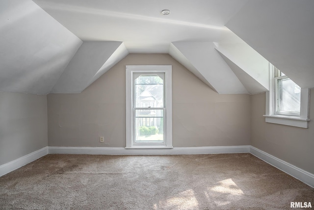 additional living space with carpet floors and vaulted ceiling