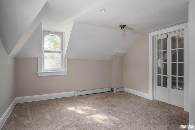 additional living space with carpet floors, a baseboard radiator, and lofted ceiling