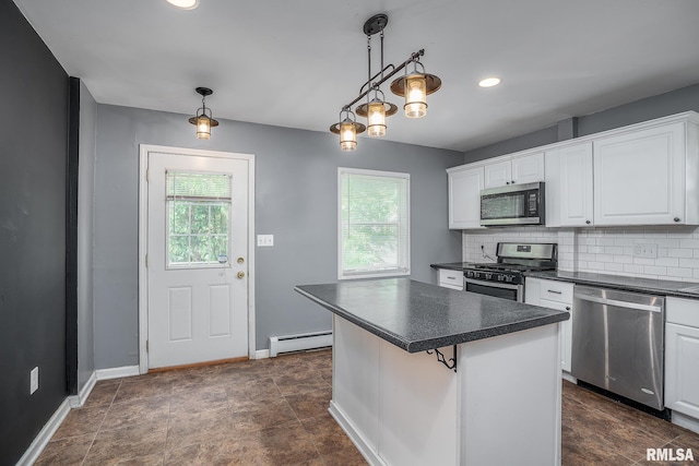 kitchen with white cabinetry, a center island, a baseboard radiator, appliances with stainless steel finishes, and pendant lighting