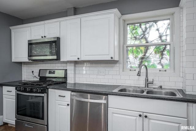 kitchen with white cabinetry, stainless steel appliances, and sink