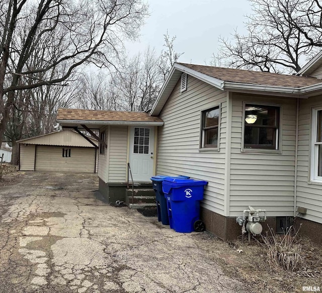 exterior space featuring a garage and an outdoor structure