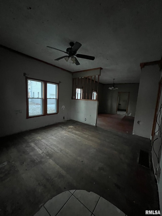 unfurnished living room with ceiling fan