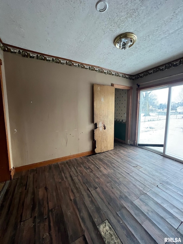 empty room featuring hardwood / wood-style floors and a textured ceiling