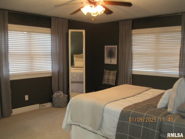 bedroom featuring ceiling fan and carpet