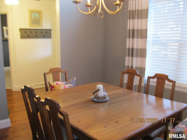 dining area featuring a chandelier and hardwood / wood-style floors