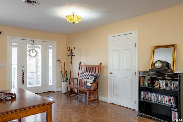 entryway with dark hardwood / wood-style flooring