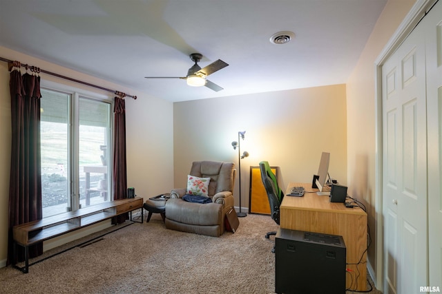 living area with ceiling fan and carpet floors