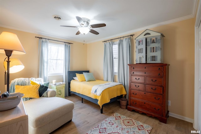 bedroom featuring crown molding, ceiling fan, and light wood-type flooring