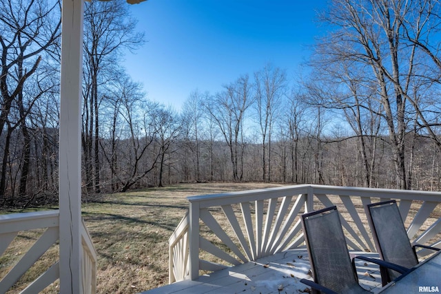 wooden deck featuring a lawn