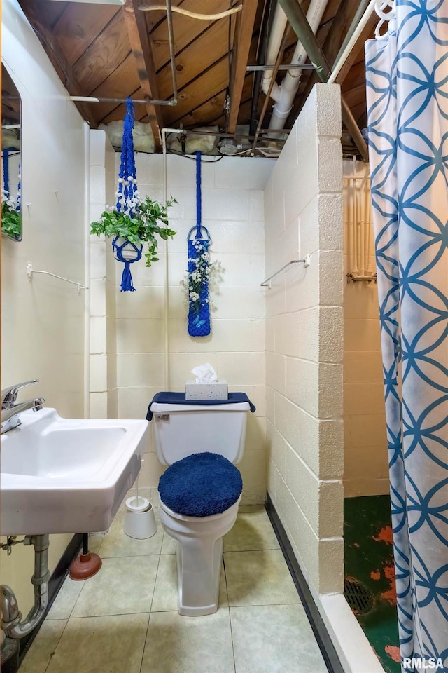 bathroom with toilet, tile patterned flooring, and a shower with shower curtain