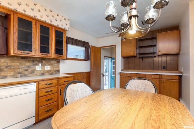 kitchen featuring white dishwasher, hanging light fixtures, and a chandelier