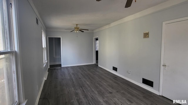 unfurnished room featuring dark hardwood / wood-style flooring, plenty of natural light, ornamental molding, and ceiling fan