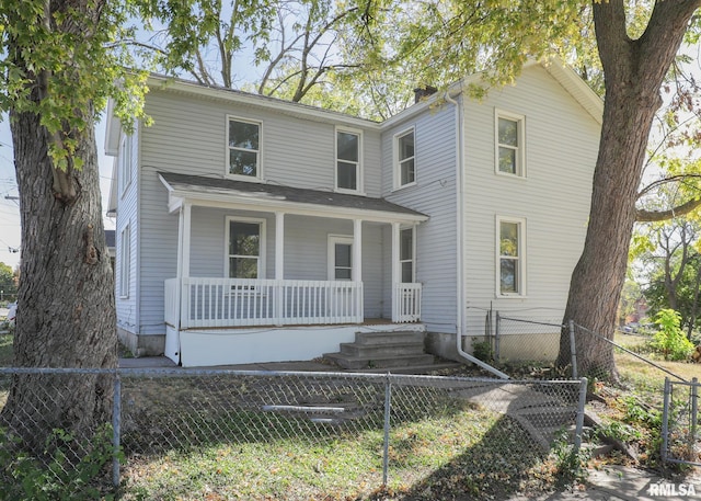 view of front of home with fence private yard and covered porch