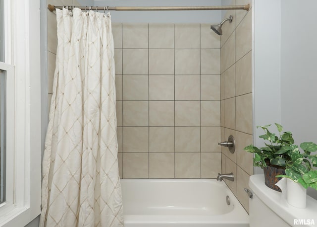 bathroom with shower / tub combo and toilet