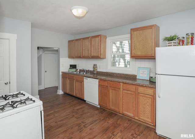 kitchen with dark hardwood / wood-style floors, sink, backsplash, and white appliances