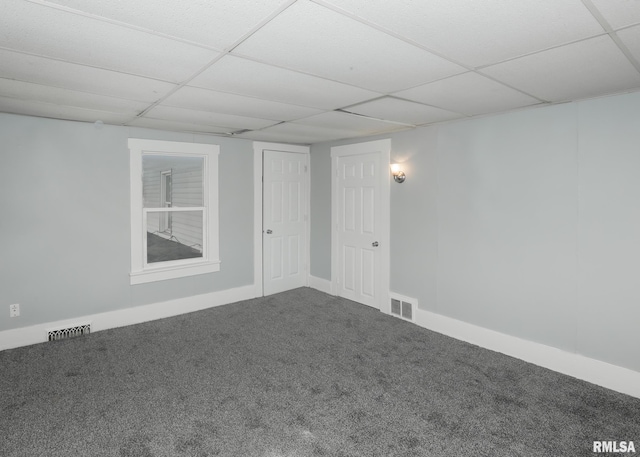 basement featuring carpet flooring and a drop ceiling