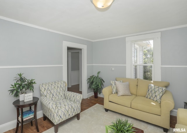 living room with hardwood / wood-style flooring and crown molding