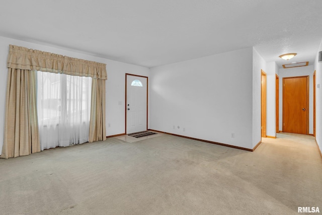 foyer with light colored carpet