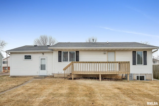 rear view of house with a wooden deck and a lawn