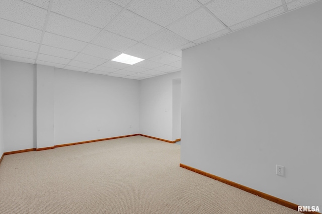 spare room featuring a drop ceiling and carpet flooring