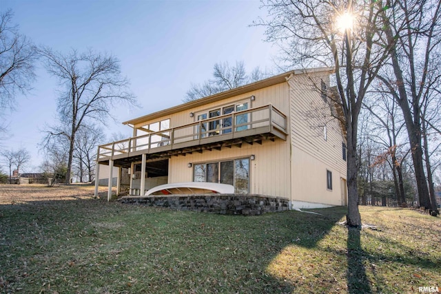 back of house featuring a wooden deck and a yard