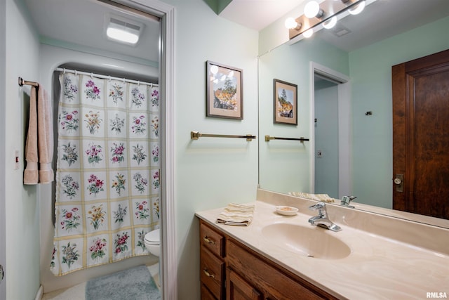 bathroom featuring vanity and toilet