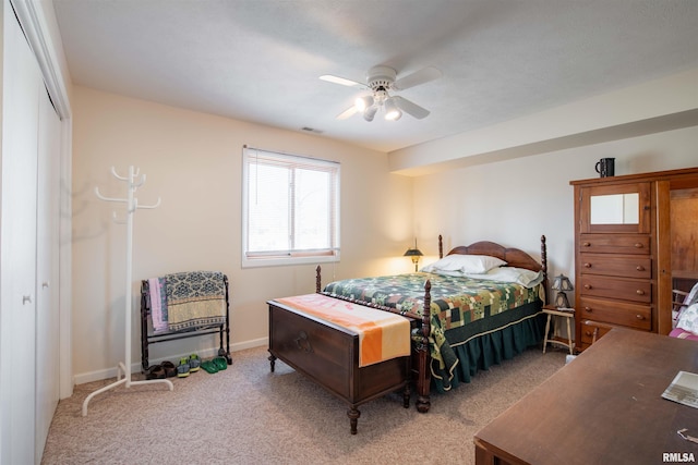 carpeted bedroom featuring ceiling fan and a closet