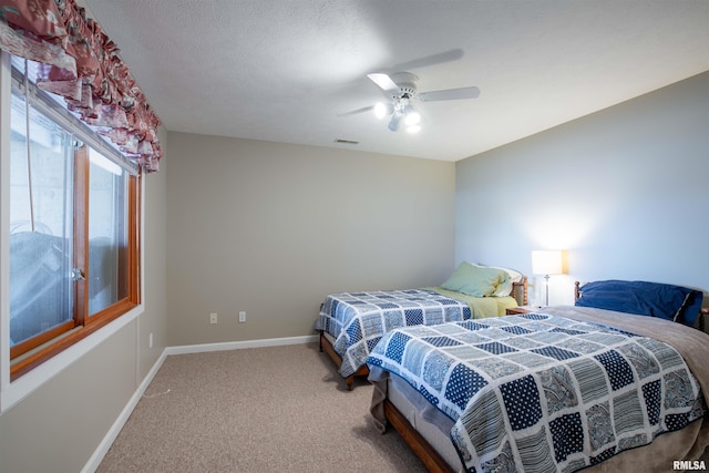 bedroom featuring carpet, a textured ceiling, and ceiling fan