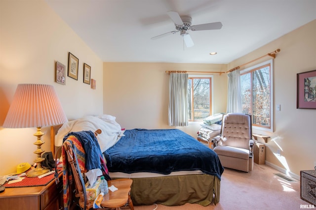 bedroom featuring light colored carpet and ceiling fan