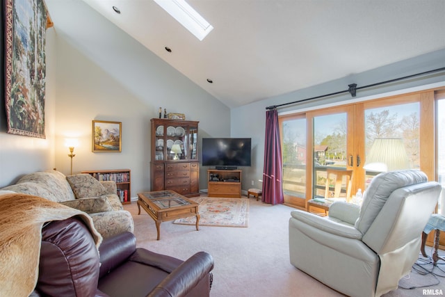 living room with light colored carpet, a skylight, high vaulted ceiling, and a wealth of natural light