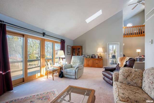 living room with plenty of natural light, a skylight, and light carpet