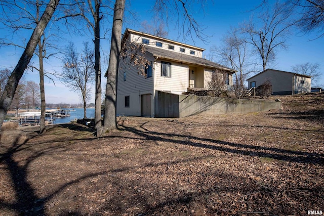 back of house featuring a water view