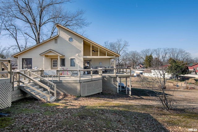 rear view of house featuring a deck and ceiling fan