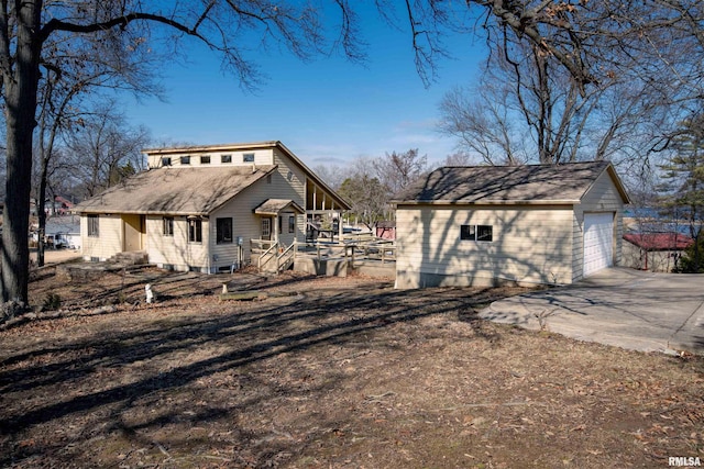 rear view of house featuring an outbuilding and a garage