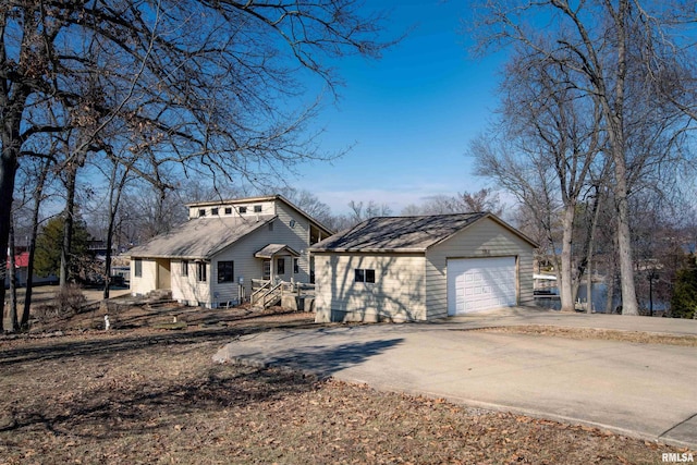 view of front facade with an outbuilding and a garage