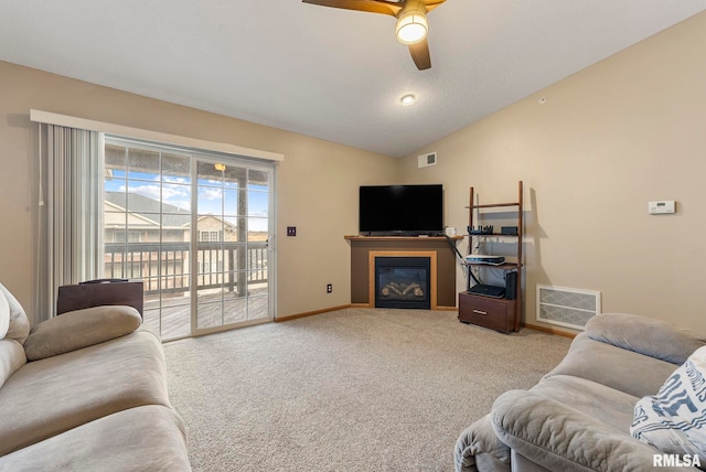 carpeted living room featuring ceiling fan and vaulted ceiling