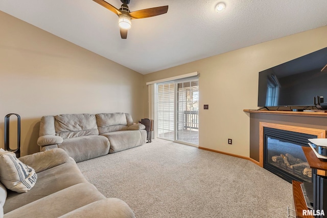 living room with vaulted ceiling, ceiling fan, and carpet flooring