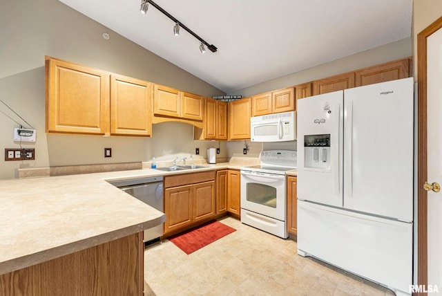 kitchen with vaulted ceiling, sink, track lighting, and white appliances