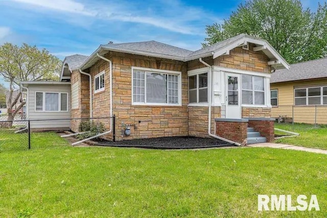 rear view of property with a lawn