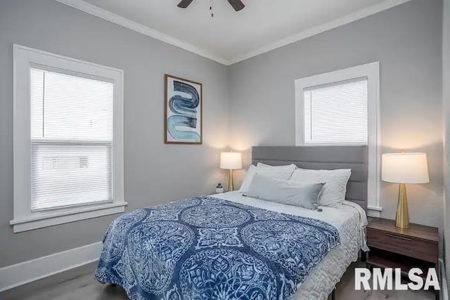 bedroom featuring ceiling fan, ornamental molding, hardwood / wood-style floors, and multiple windows