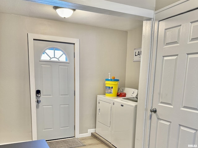 laundry room featuring light hardwood / wood-style floors and independent washer and dryer