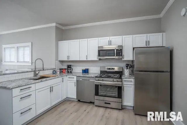 kitchen featuring white cabinetry, stainless steel appliances, and sink