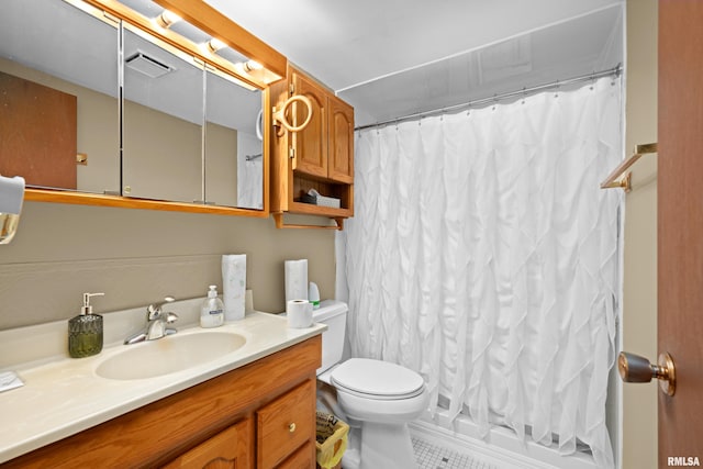 bathroom featuring vanity, tile patterned flooring, and toilet