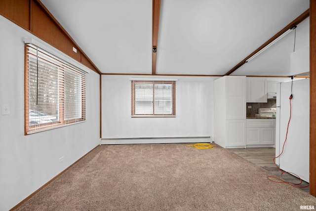 carpeted empty room featuring a baseboard radiator and vaulted ceiling